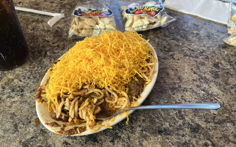A Skyline Chili 3-Way topped with shredded cheddar