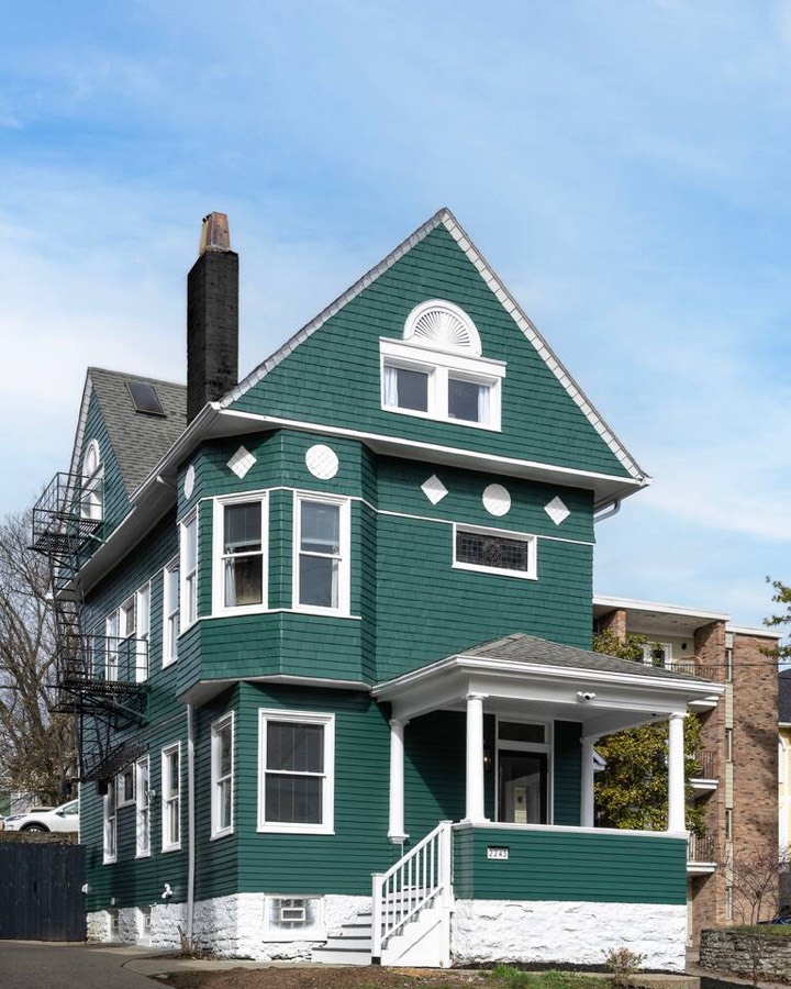 The house from the street — a restored green Victorian with white trim and a covered front porch — Cincy Historic Gem, East Walnut Hills, Cincinnati