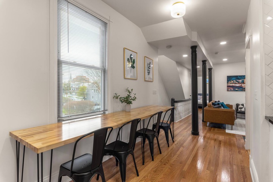 A long butcher-block table down the middle of the room — this is where a big group ends up eating.