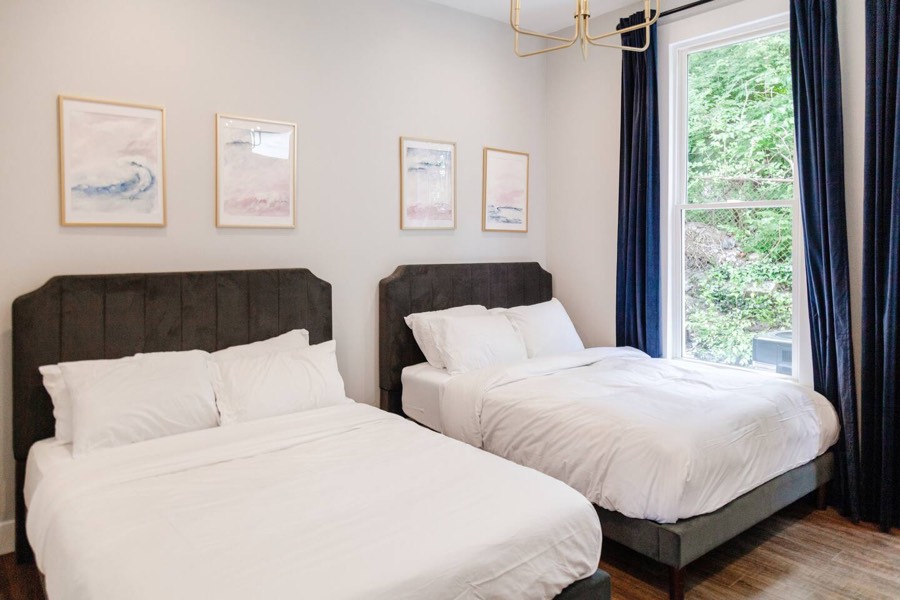 Unit 1, bedroom 1 — two queen beds, with its own bathroom
