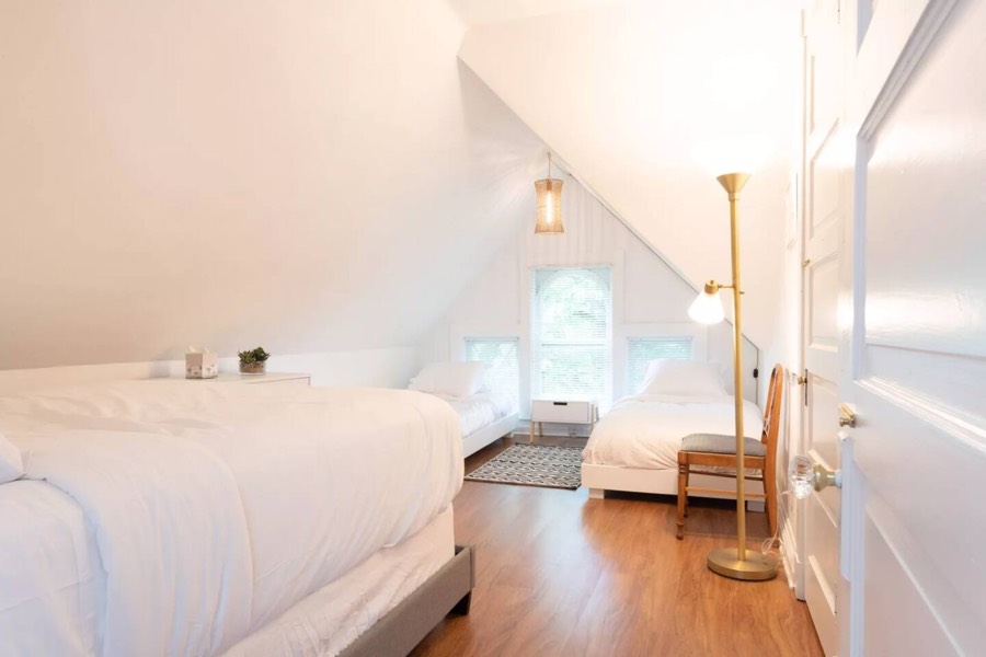 The large third-floor main bedroom — 1 queen and 2 twin beds
