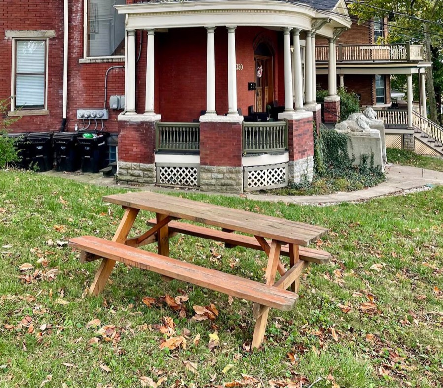 Outdoor eating area in the side yard, under the shade of mature trees